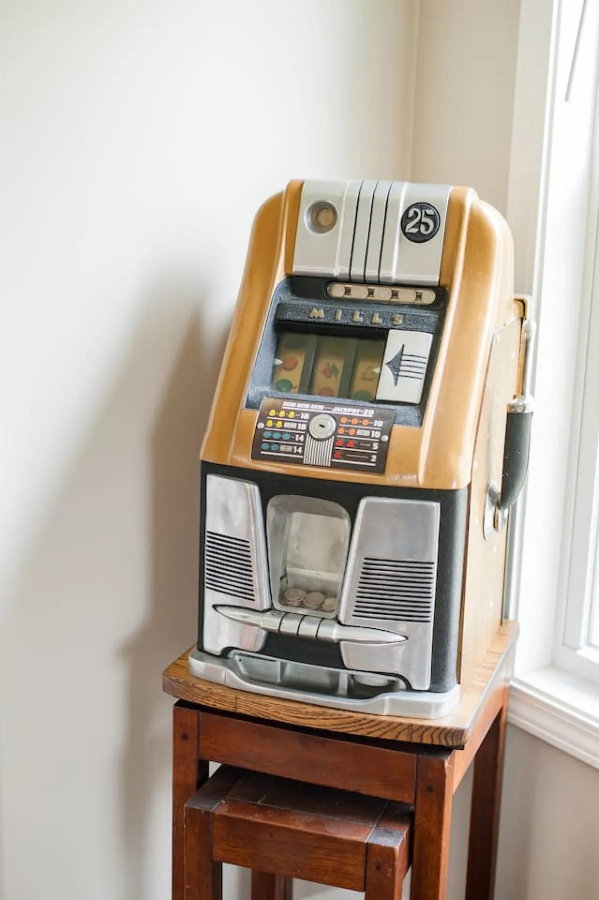 A playful corner featuring a vintage slot machine and a wooden stool, inviting moments of fun and nostalgia. The scene hints at unique, personal touches that make the farmhouse experience memorable.